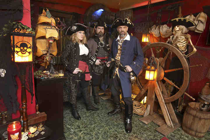 Trinity Hinton (a.k.a "Trinity"), Ken Smith (a.k.a "Hatteras Jack") and Stephen Hinton (a.k.a. "Captain Blade") are a group of pirates who do fundraising for local groups. The group, known as "Pirates of the Rusty Cutlass," are shown in the Hinton's home in Canton.    (Scott Heckel / The Canton Repository)